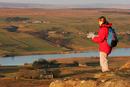 06-2010 Hill Walker with map enjoying the view over Baldersdale from Goldsborough Crag, Teesdale County Durham.